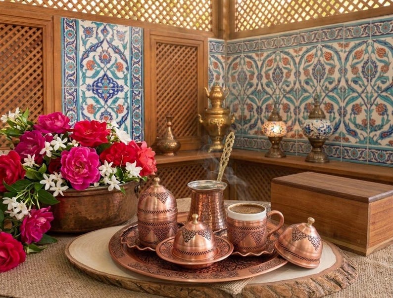 May include: A copper Turkish coffee set with two cups, saucers, and a cezve. The set is decorated with intricate floral patterns and is displayed on a wooden tray.