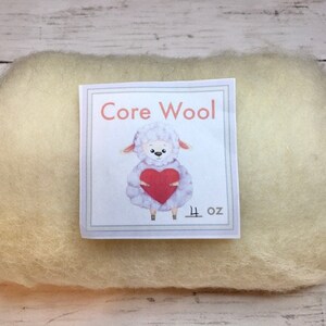 May include: A 4 ounce package of white core wool for felting. The package has a label with a cartoon sheep holding a red heart and the text "Core Wool".