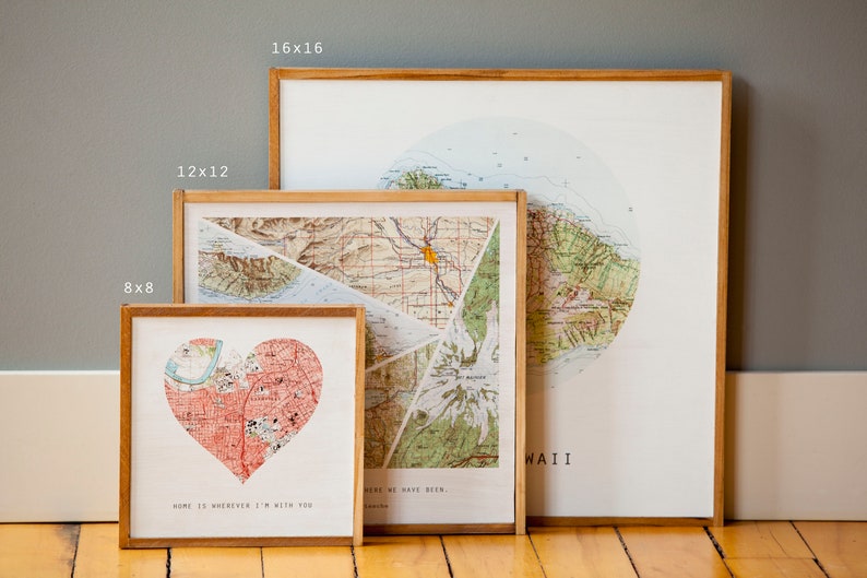 May include: Three framed maps of Hawaii, with different sizes and designs. The smallest map is a heart-shaped design with the text "Home is wherever I'm with you". The middle map is a collage of different map sections with the text "Here we have been". The largest map is a circular design with the text "Hawaii".