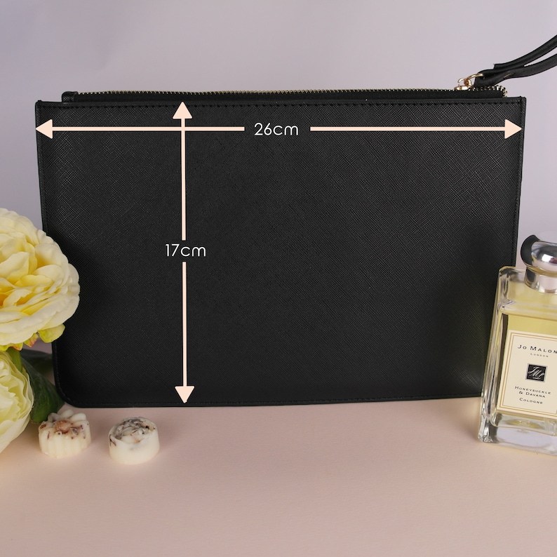 May include: Black zippered clutch bag with a textured finish. The bag measures 17 inches by 26 inches.