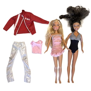 May include: A collection of doll clothing and two dolls. The clothing includes a red jacket with white stripes and the text "EHS", silver pants, a pink tank top, and a pink dress. One doll wears a black and white striped swimsuit.