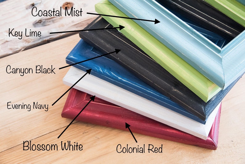 May include: A stack of six picture frames in various colors, including colonial red, blossom white, evening navy, canyon black, key lime, and coastal mist.