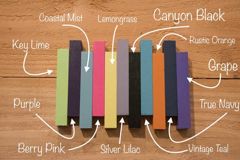 May include: A collection of ten paint color samples, each labeled with a different color name. The colors are: Coastal Mist, Lemongrass, Canyon Black, Rustic Orange, Grape, True Navy, Vintage Teal, Berry Pink, Silver Lilac, and Key Lime.