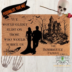 May include: A Halloween-themed doormat with a spooky design. It features a silhouette of a couple, a haunted house, bats, and the text "WE WOULD GLADLY FEAST ON THOSE WHO WOULD SUBDUE US." The mat is personalized with "THE RODRIGUEZ FAMILY."