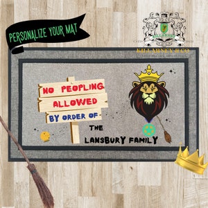 May include: A rectangular doormat with a gray border and a light gray center. The mat features a lion wearing a crown, a sign that reads "NO PEOPLING ALLOWED," and the text "THE LANSBURY FAMILY." The words "PERSONALIZE YOUR MAT" are also present.
