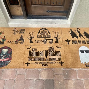 May include: A collection of six rectangular coir doormats with Halloween-themed designs. The mats feature various spooky graphics, including a clown, ghosts, and text like "Room for one more?" and "The Haunted Mansion."