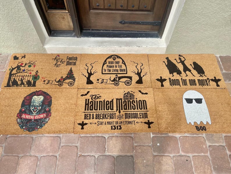 May include: A collection of six rectangular coir doormats with Halloween-themed designs. The mats feature various spooky graphics, including a clown, ghosts, and text like "Room for one more?" and "The Haunted Mansion."