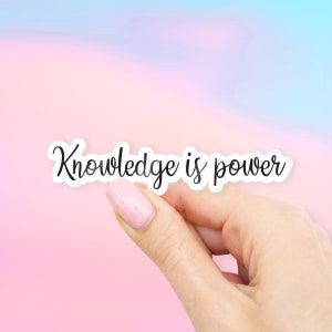 May include: A white sticker with black text that reads "Knowledge is power" on a pink and blue gradient background.