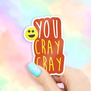 May include: A red sticker with white text that says "YOU CRAY CRAY" and a yellow smiley face.