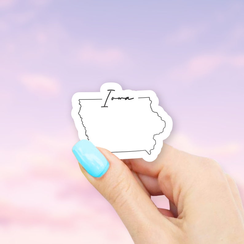 May include: A white sticker with a black outline of the state of Iowa and the word "Iowa" written in cursive.