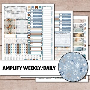 May include: A collection of planner stickers with a winter theme. The stickers feature snowflakes, ornaments, and decorative elements in shades of blue, brown, and white. The text "AMPLIFY WEEKLY/DAILY" is displayed at the bottom.
