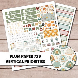 May include: A sticker sheet labeled Plum Paper 7x9 Vertical Priorities featuring daily headers, a calendar, and icons of pumpkins, sweaters, and household items. The sheet includes various rectangular labels, flags, and a circular pattern of sweaters.