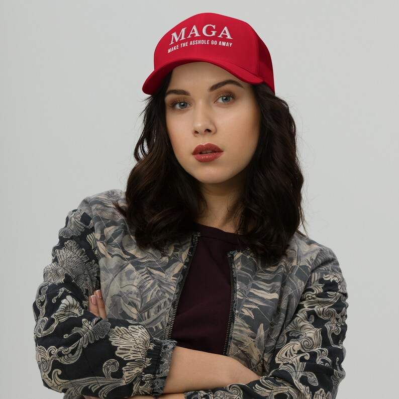 May include: A red baseball cap with a white embroidered logo that reads "MAGA MAKE THE ASSHOLE GO AWAY".