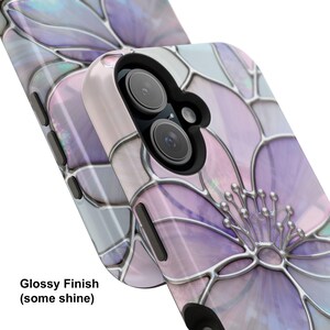 May include: Two phone cases with a floral design are shown. The cases have a glossy finish and a stained-glass effect in shades of purple, pink, and silver. The text "Glossy Finish (some shine)" is visible on the bottom left.