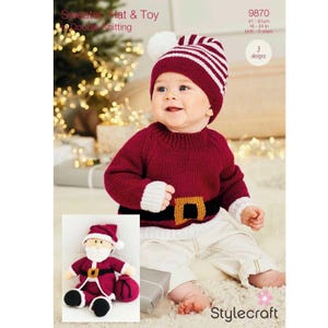 May include: A red and white striped knit hat with a white pom pom on top. A baby is wearing the hat and a red knitted sweater with a white trim and a brown belt. The sweater has a Santa Claus design on the front. A knitted Santa Claus toy is sitting on a white surface.
