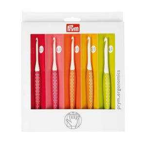 May include: A set of six ergonomic crochet hooks in a white box. The hooks have white tips and colorful handles in shades of red, pink, orange, and green. The sizes are labeled 3.5, 4.0, 4.5, 5.0, and 6.0. The box has the brand name "Prym" and the text "prym.ergonomics".