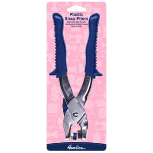 May include: Plastic snap pliers with blue soft-grip handles. The pliers are silver and designed for use with Hemline plastic snaps, size 20 (T5). The packaging is pink with sewing-themed illustrations and the Hemline logo.