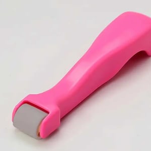 May include: A pink plastic roller with a gray roller head. The roller is designed to help smooth out wrinkles and fine lines.