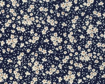 Tela de popelina de algodón con estampado floral de margaritas blancas sobre azul marino