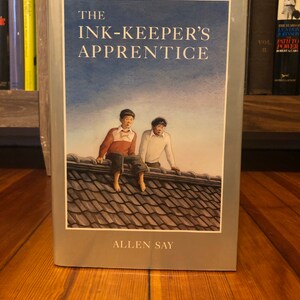 The Ink-keepers Apprentice by Allen Say, Houghton Mifflin Company, 1994, first printing of this edition, signed with a doodle image 1