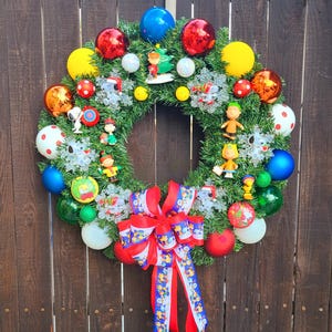 Peanuts Holiday Wreath with musical color changing led lights, featuring Snoopy, Woodstock, Charlie Brown and Friends