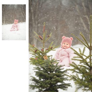 May include: A baby wearing a pink snowsuit and a matching knit hat with bear ears sits in the snow near evergreen trees. The background shows a snowy forest scene with falling snowflakes.