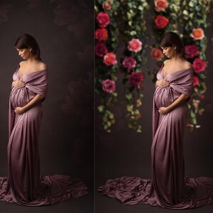 May include: A pregnant person wearing a long, flowing, mauve-colored gown with a draped shawl. The background is a dark brown with a floral pattern.