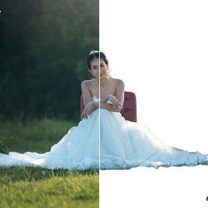 May include: A bride in a white wedding dress sits on a red chair in a grassy field. The background is blurred and the bride is smiling at the camera.