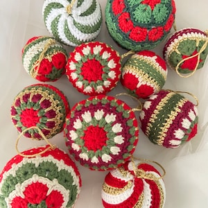 May include: Ten crocheted Christmas ornaments in various red, green, and white patterns. The ornaments are made with a variety of stitches and textures, including stripes, swirls, and geometric designs.