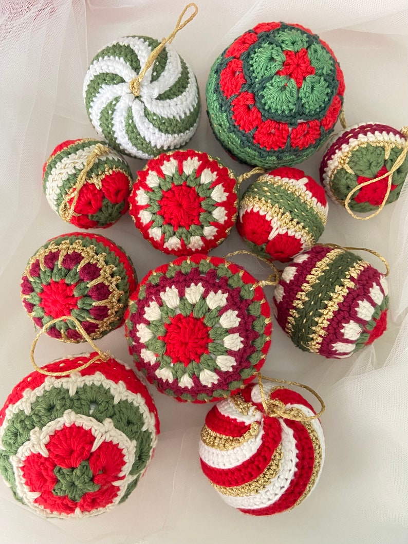 May include: A collection of ten crocheted Christmas ornaments in various red, green, white and gold patterns. The ornaments are displayed on a white background.