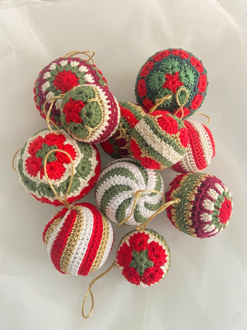 May include: A collection of nine crocheted Christmas ornaments in red, green, white, and gold. The ornaments are all different designs, including stripes, swirls, and geometric patterns.