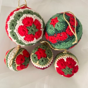 May include: Five crocheted Christmas ornaments in red, green, and white. The ornaments are decorated with a flower pattern.
