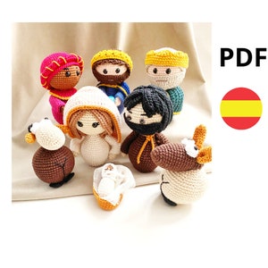 May include: Crochet nativity scene with a brown donkey, a brown sheep, a white baby Jesus in a manger, a white Mary, a brown Joseph, a black and white wise man, a red and gold wise woman, and a yellow and gold wise man.