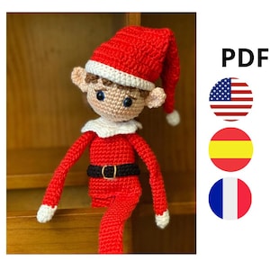 Peut inclure: Patron de crochet pour un lutin en crochet rouge et blanc avec un chapeau marron. Le patron est disponible en format PDF et comprend des instructions en anglais, espagnol et français.
