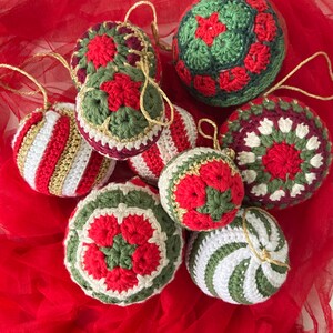 May include: A collection of eight crocheted Christmas ornaments in red, white, and green. The ornaments feature various patterns, including stripes, snowflakes, and flowers.