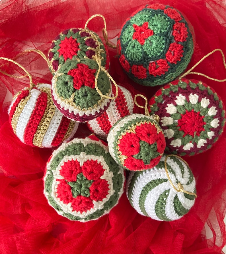 May include: A collection of eight crocheted Christmas ornaments in red, white, and green. The ornaments feature various patterns, including stripes, snowflakes, and flowers.