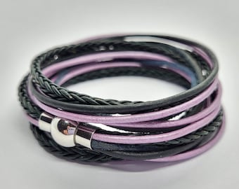 May include: A multi-layered bracelet with black and purple leather straps and a silver metal clasp.