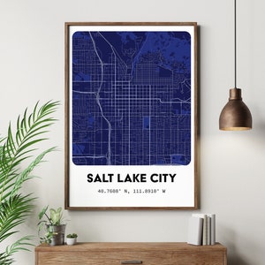 May include: A blue and white map print of Salt Lake City, Utah. The map shows the city streets and landmarks. The text "SALT LAKE CITY" and the coordinates "40.7608° N, 111.8910° W" are printed below the map.
