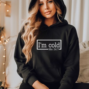 May include: Black hooded sweatshirt with the text "I'm cold - Me 24/7" in a white box.