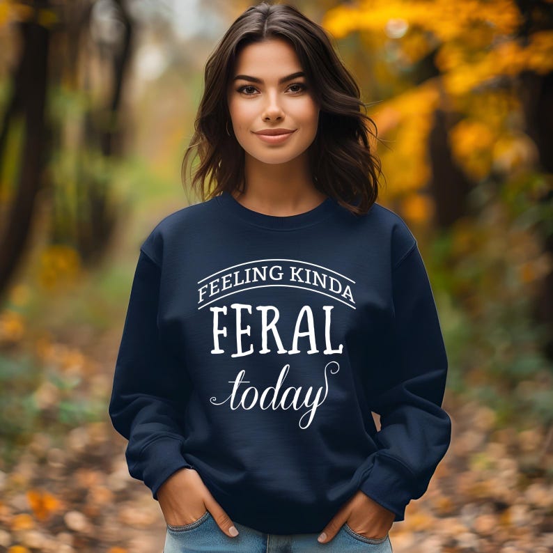 May include: A navy blue sweatshirt with the text "Feeling Kinda Feral Today" in white.