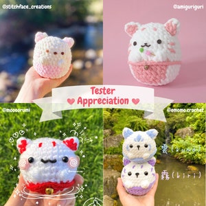 May include: Four crocheted stuffed animals in the shape of cats. The cats are white with pink, red, and blue accents. The cats are holding a small red heart, a small red bell, a small red heart, and a small red bell. The cats are sitting on a green surface. The text "Tester Appreciation" is written in white letters on a pink background.