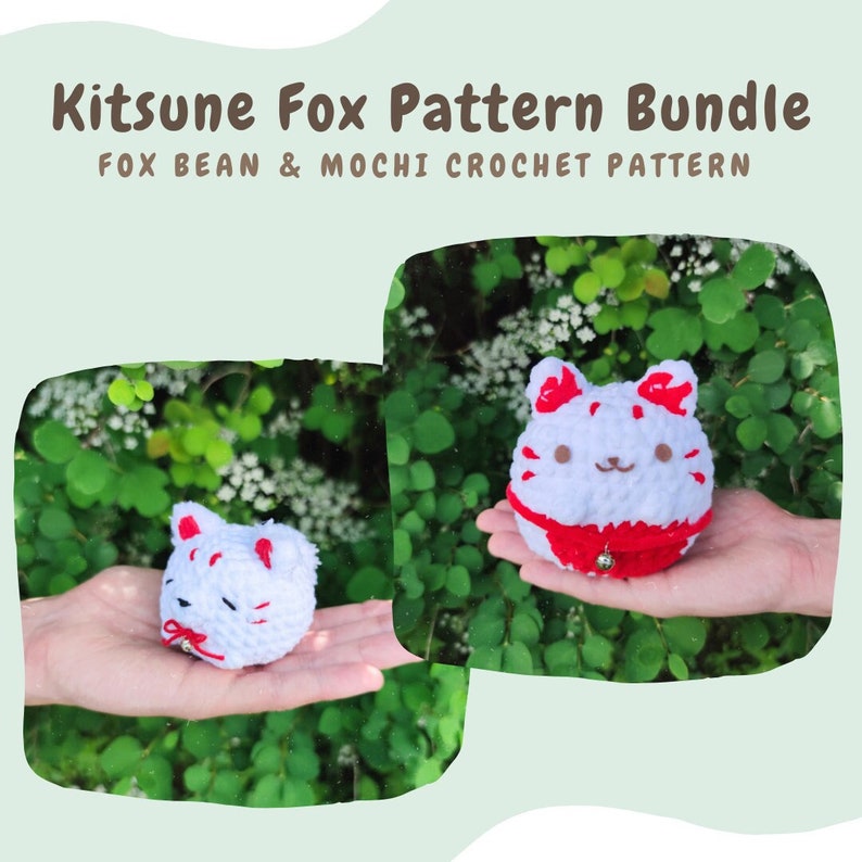 May include: Two white crocheted kitsune fox plushies with red accents. The fox on the left is laying down with its head tilted to the side. The fox on the right is sitting up with its ears perked up. Both foxes have a red bell hanging from their necks. The image is set against a background of green leaves.
