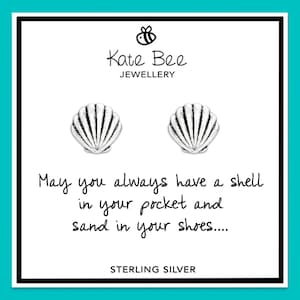 May include: Sterling silver earrings featuring a seashell design. The earrings are packaged in a white card with the text "May you always have a shell in your pocket and sand in your shoes..." and "Kate Bee Jewellery" printed on it.