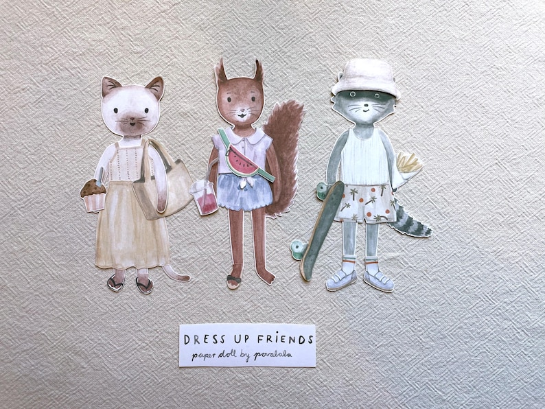May include: Watercolor paper dolls of three animal characters: a cat, a squirrel, and a raccoon. The cat holds a cupcake and a tote bag. The squirrel has a watermelon fanny pack. The raccoon has a skateboard. The text reads "DRESS UP FRIENDS paper doll by poralala."