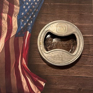 May include: A circular silver-toned metal Presto jar opener with an integrated bottle opener. The metal surface features embossed text including 'The Presto Jar and Closure are approved by Good Housekeeping Institute' and 'Pat. Re 17520'.