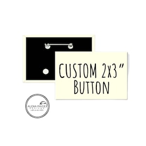 May include: A white button with black text that reads "CUSTOM 2x3" BUTTON. The button is shown next to a blank, white button with a black backing.
