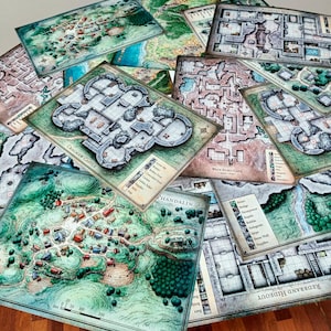 May include: A stack of various fantasy role-playing game maps, including a map of the town of Phandalin, a map of Cracmaw Castle, and a map of Wave Echo Cave. The maps are printed on thick paper and have a detailed, hand-drawn style.