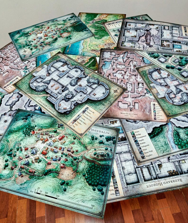 May include: A stack of various fantasy role-playing game maps, including a map of the town of Phandalin, a map of Cracmaw Castle, and a map of Wave Echo Cave. The maps are printed on thick paper and have a detailed, hand-drawn style.