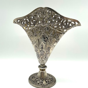 May include: A set of three ceramic mugs with a speckled, matte finish. The mugs are in shades of cream, light gray, and dark gray. Each mug has a simple, minimalist design, perfect for coffee or tea.