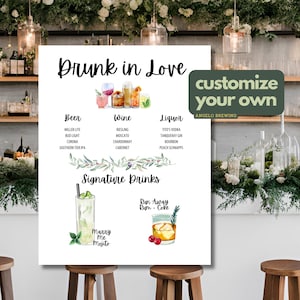 May include: A white sign with the text "Drunk in Love" and a list of beer, wine, and liquor options. The sign also includes two signature drinks: "Marry Me Mojito" and "Run Away Rum & Coke".